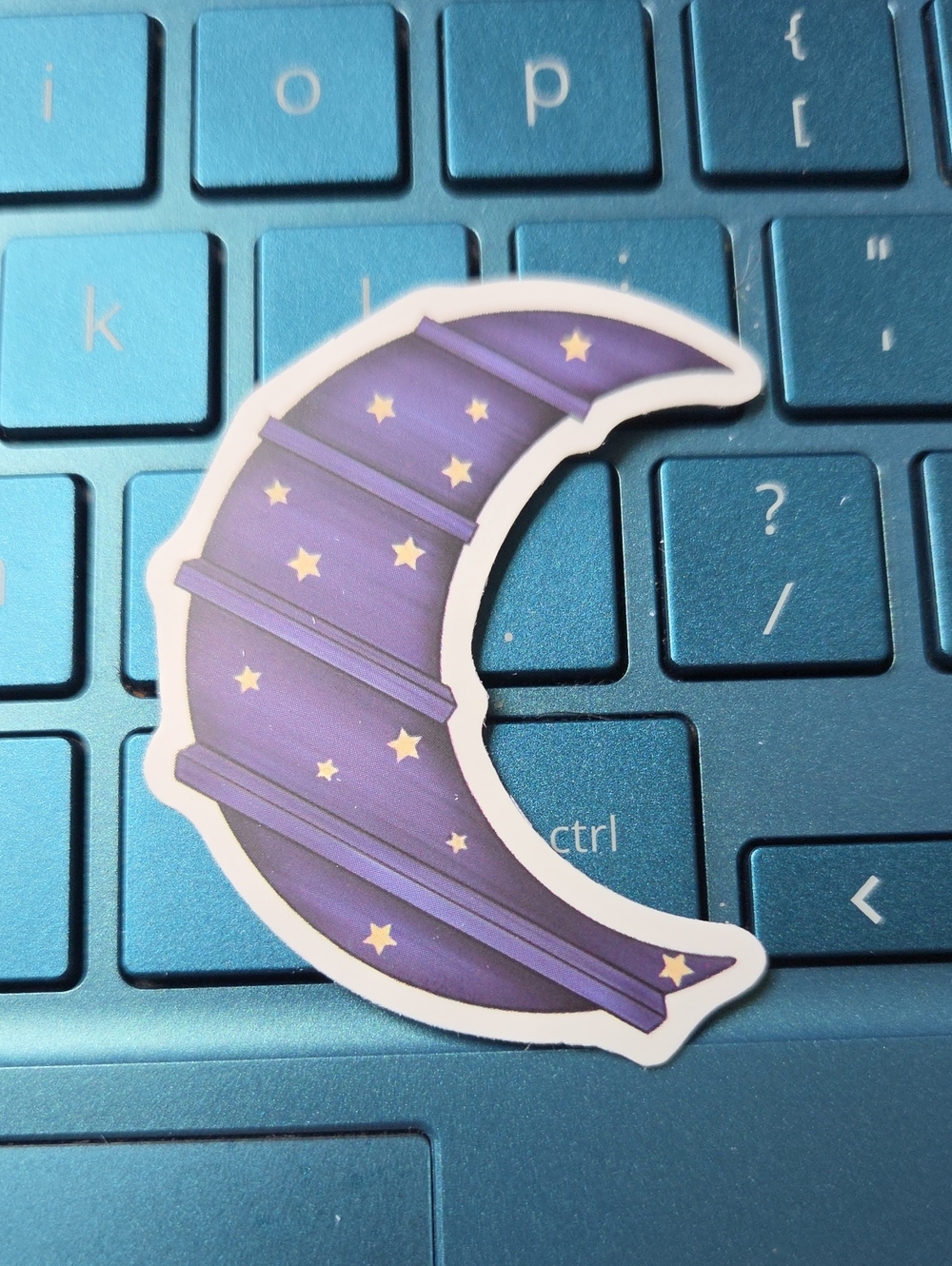 Blue Laptop Keyboard with Purple Crescent Moon Sticker